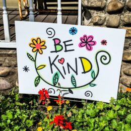 Kindness poster in a garden